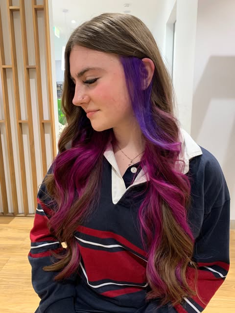 Long brunette hair with a vivid violet panel underneath