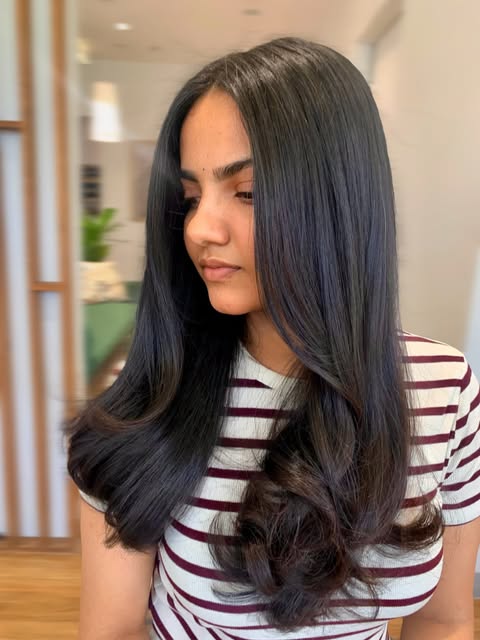 Long dark hair, sleek blow wave finish