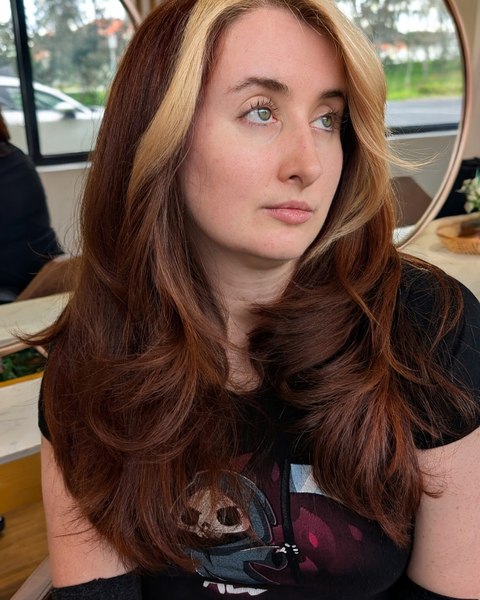 A copper red colour with a lighter money piece at the front, cut in long layers