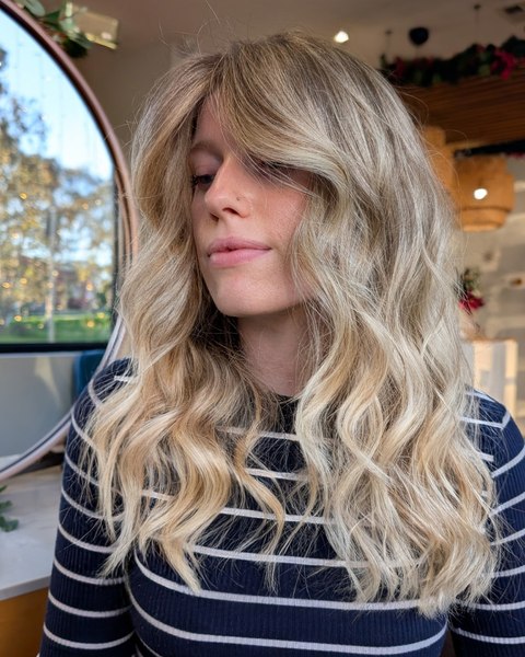 A soft blonde with a fringe and long beachy waves