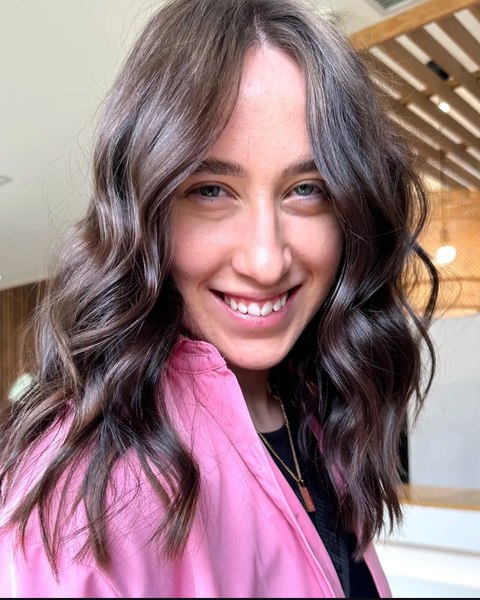 A brunette with soft waves, cut and styled in the salon