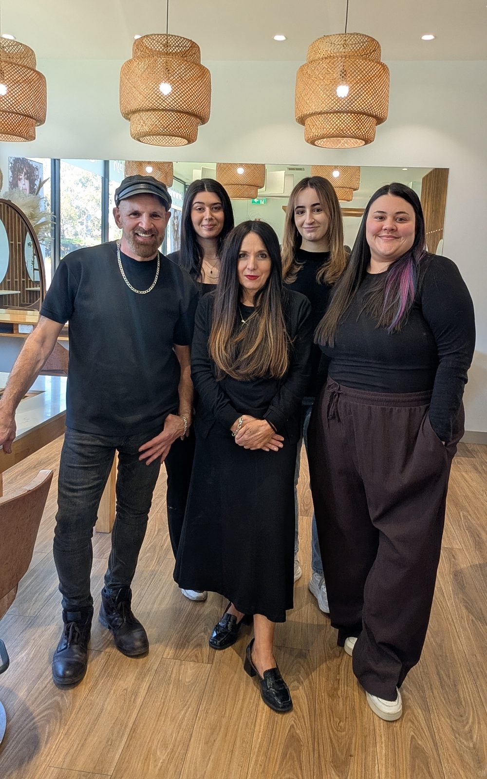 The five members of the Signature Look team standing together in the salon