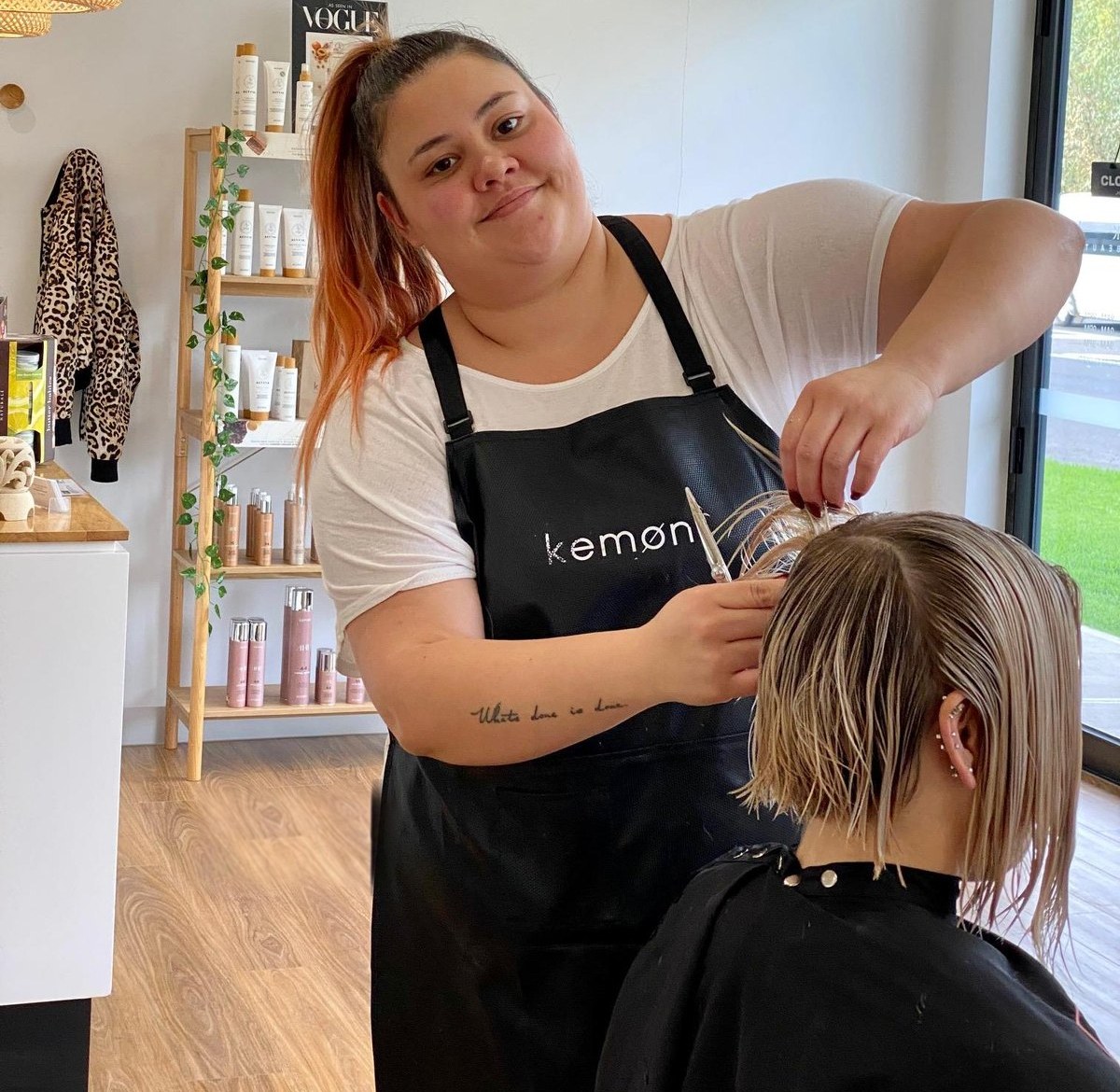A stylist cutting a client's hair at Signature Look in Mill Park